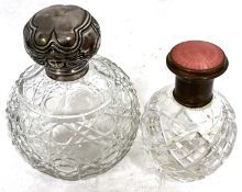 An early 20th Century cut glass and silver lidded scent bottle of globular form with hinged collar