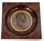 An early 19th Century bronze medallion of Napoleon in portrait relief, framed in a birds eye maple