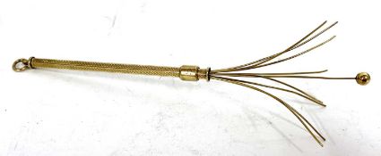 A 9ct gold swizzel stick cocktail stirer, the hexagonal barrel with engine turned decoration, and