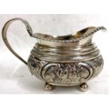 George III silver cream jug of oval form, applied gadrooned rim, embossed body and handle