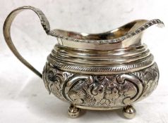 George III silver cream jug of oval form, applied gadrooned rim, embossed body and handle