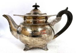 A George V silver teapot of globular form applied with shell and gadrooned border, an acanthus