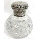 A late Victorian scent bottle, having cut glass globular body with a hinged silver embossed lid