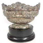 A Victorian silver presentation bowl of oval form having a pierced border and elaborately embossed