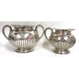 A Victorian silver twin handled sugar bowl and matching cream jug of oval form, the body with part