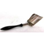 A George III silver caddy spoon with shovel shaped bowl and turned ebonised handle, hallmarked for