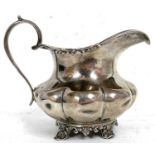 Victorian silver cream jug of oval form applied with a reeded and floral border, part fluted body