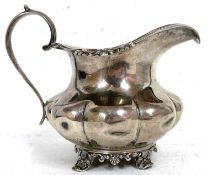 Victorian silver cream jug of oval form applied with a reeded and floral border, part fluted body