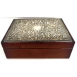 Modern silver topped jewellery box embossed with scrolls, flowers etc around a plain cartouche,