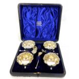 Late Victorian cased set of four open salts and spoons of circular form with beaded crimped edges