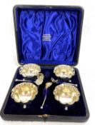 Late Victorian cased set of four open salts and spoons of circular form with beaded crimped edges