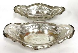 A pair of Edwardian silver bon bon dishes of shaped oval form, pierced with scrolls etc,