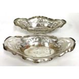 A pair of Edwardian silver bon bon dishes of shaped oval form, pierced with scrolls etc,