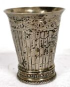 A antique Dutch silver small beaker of tapering form with flared rim, engraved with garlands and