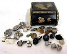 A lacquered Chinese style box containing a small quantity of mixed buttons