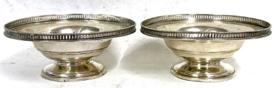 A pair of George VI silver pedestal dishes of circular squat form with applied pierced edges,