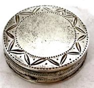 A George III silver patch box of circular form, the pull off covered lid with chased and engraved