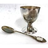 A cased white metal egg cup and spoon, both stamped 800