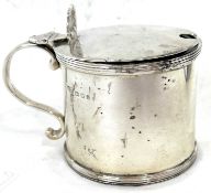 A George V silver drum mustard of typical form with reeded edges, shell thumb piece hinged lid,
