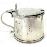 A George V silver drum mustard of typical form with reeded edges, shell thumb piece hinged lid,
