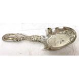 A George IV silver caddy spoon, fiddle and shell pattern, the shaped bowl chased and engraved with a