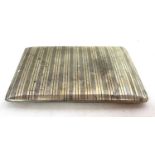 A white metal cigarette case of rectangular form with overall engraved banded design, 12 x 8cm,