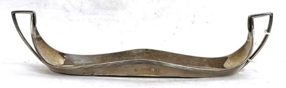 A George III silver boat shaped ink stand with applied reeded border and twin handles, centre ink