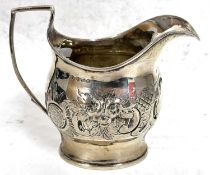 George III silver cream jug of oval form, the body decorated and embossed with foliage around an