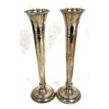 Pair of Elizabeth II silver tall spill vases having beaded decoration to rims and bases, engraved