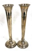 Pair of Elizabeth II silver tall spill vases having beaded decoration to rims and bases, engraved