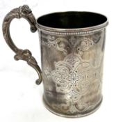 A Victorian silver tankard of cylindrical form, the body engraved with interlacing scrolls around an
