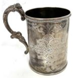 A Victorian silver tankard of cylindrical form, the body engraved with interlacing scrolls around an