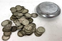 Seventy 3d silver pence coins, various dates, 99 gms, housed in a metal compact