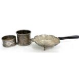 Mixed Lot: An ornate chased and engraved tea strainer on three feet with ebonised handle marked