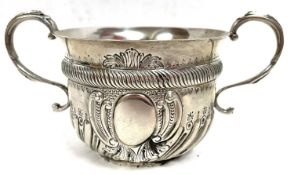 An Edward VII silver porringer of rounded form, the lower portion embossed with fluted decoration in