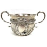 An Edward VII silver porringer of rounded form, the lower portion embossed with fluted decoration in