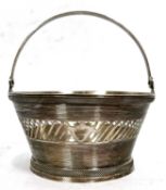 An antique Dutch silver small sugar basket, circa 1900, a reeded and pierced design with swing