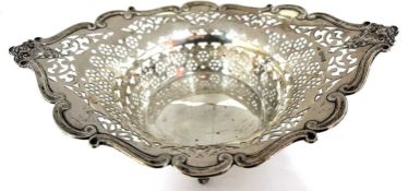 An Edwardian silver pierced basket of oval form, the rim applied with scrolls and masks and the body