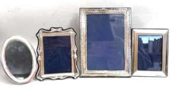 Four silver photograph frames to include a large rectangular frame with easel back, Birmingham 1917,
