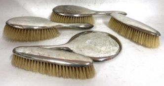 George VI silver backed dressing table wares to include two hairbrushes, hand mirror, two clothes