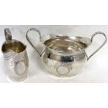 An Edwardian silver twin handled sugar bowl of oval form with engraved and wriggle work decoration