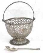A George III silver sugar basket of squat circular form, overall pierced with lattice design, one