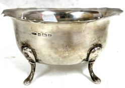 A George VI silver sugar bowl of oval form having a wavey rim and supported on four curved feet,
