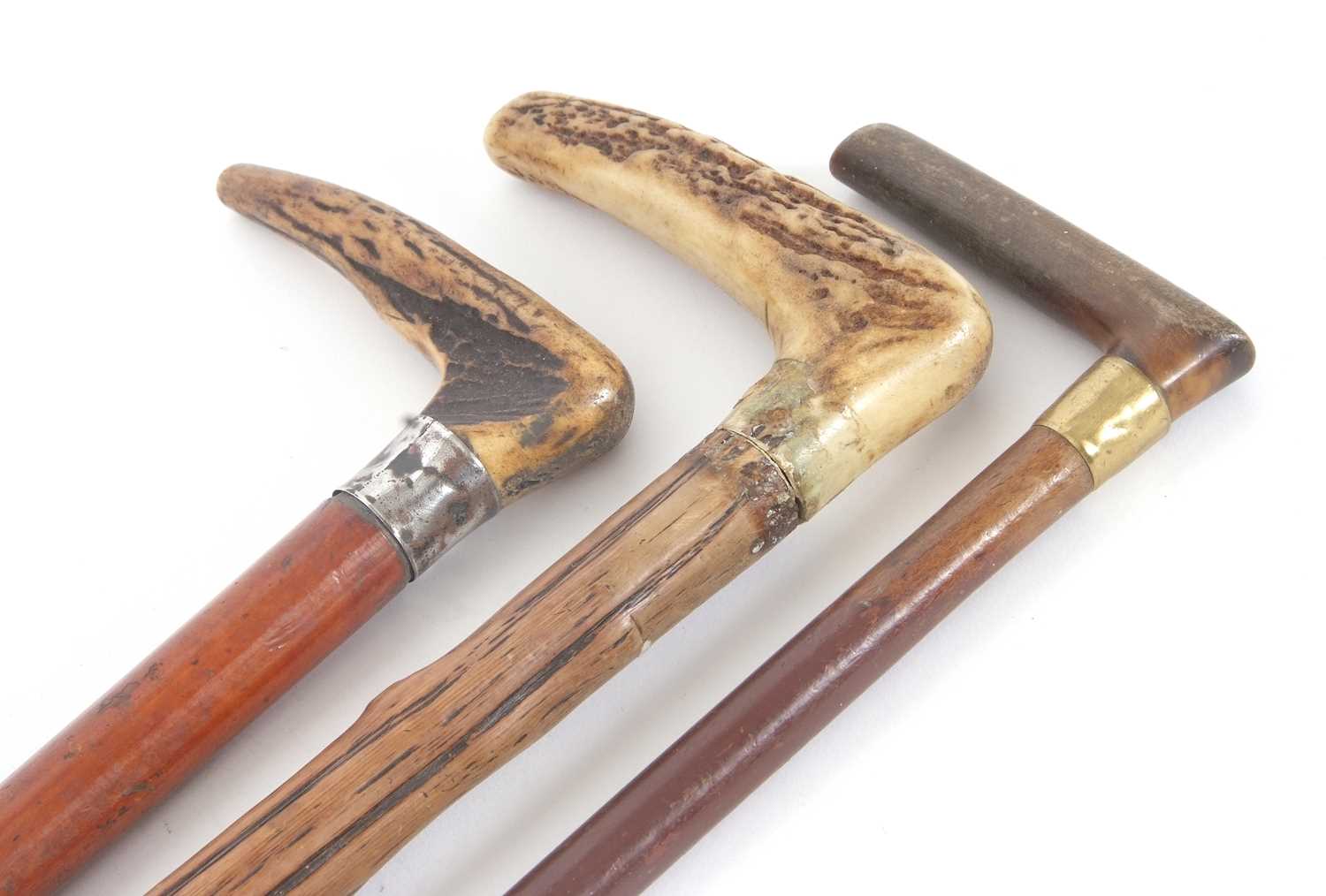 Three vintage walking sticks, two stag horn handled examples and one other (a/f) (3)