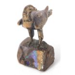 A heavy cast paperweight model of an eagle mounted on a rock base highlighted with polished opal