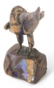 A heavy cast paperweight model of an eagle mounted on a rock base highlighted with polished opal