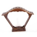 A stained wooden fan shaped stick stand for twelve sticks 2 feet 4 inches tall