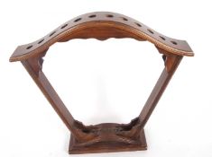 A stained wooden fan shaped stick stand for twelve sticks 2 feet 4 inches tall