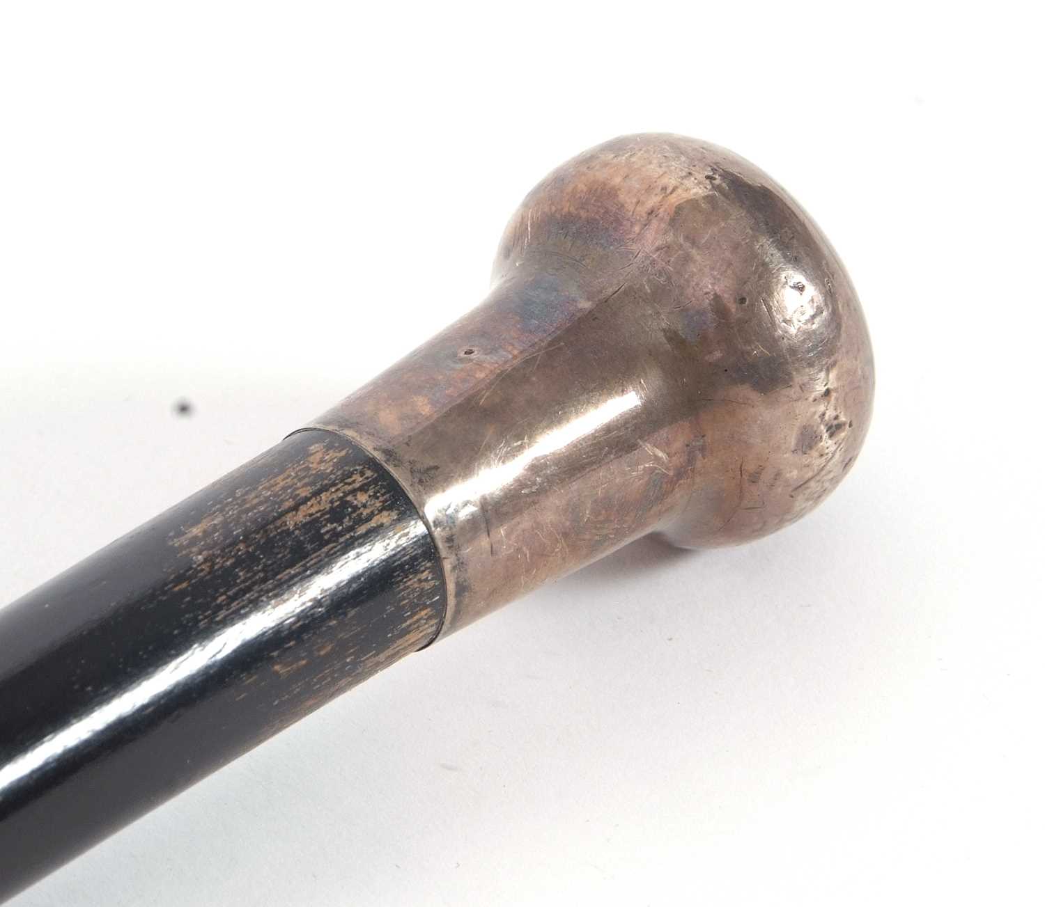 An early 20th Century black painted tapering cane, hallmarked silver handle for London 1920, - Image 4 of 4