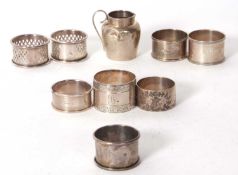 A group of eight silver serviette rings of various dates and makers together with a small hallmarked